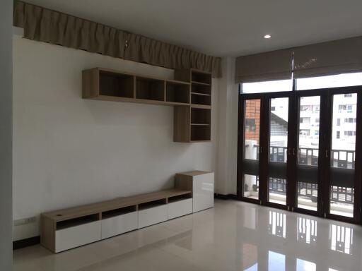 Minimalist living room with large windows and modern shelving unit