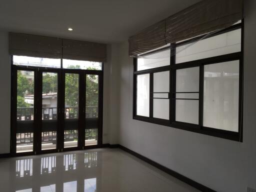 Spacious living room with large windows and glass doors