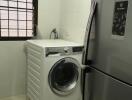 Laundry room with washing machine and refrigerator