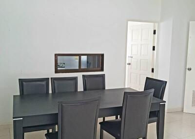 Modern dining room with a sleek black table and six chairs