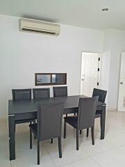 Modern dining room with a sleek black table and six chairs