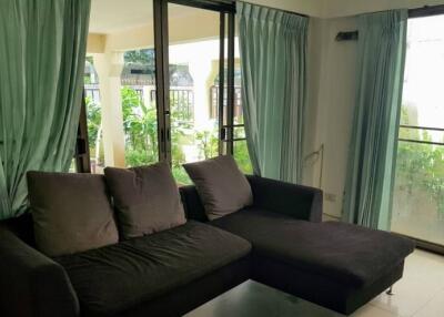 Living room with large windows and green curtains