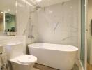 Modern bathroom with a bathtub, toilet, and shower