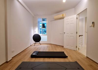 Minimalist bedroom with yoga mats and exercise equipment