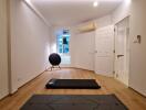 Minimalist bedroom with yoga mats and exercise equipment