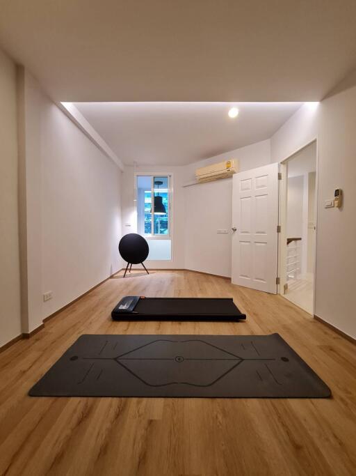 Minimalist bedroom with yoga mats and exercise equipment