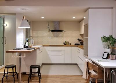 Modern kitchen with bar stools and work desk