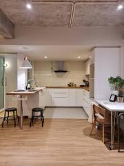 Modern kitchen with bar stools and work desk