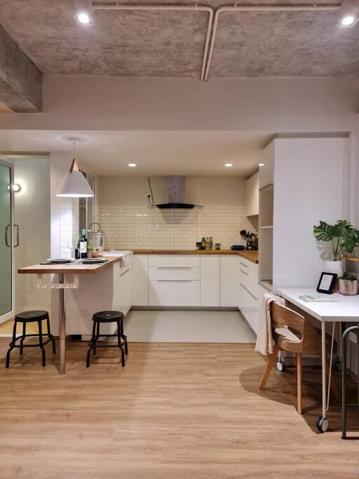 Modern kitchen with bar stools and work desk