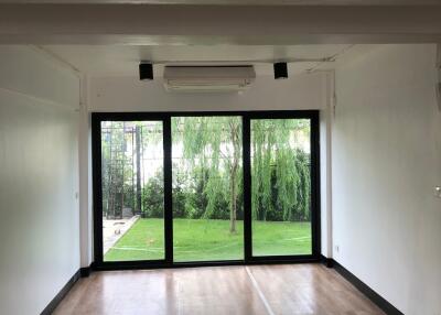 Modern living room with large glass doors opening to a garden