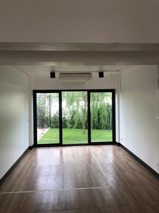 Modern living room with large glass doors opening to a garden