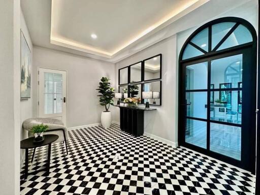 Elegant foyer with checkered flooring and modern decor