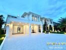 Exterior view of a modern, luxurious home with well-manicured landscaping