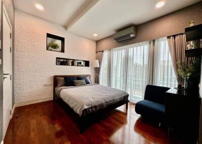 Spacious modern bedroom with wooden floor