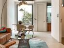 Modern living room with glass table, stylish rug, and adjacent dining area.