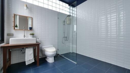 Modern bathroom with shower, sink, and toilet