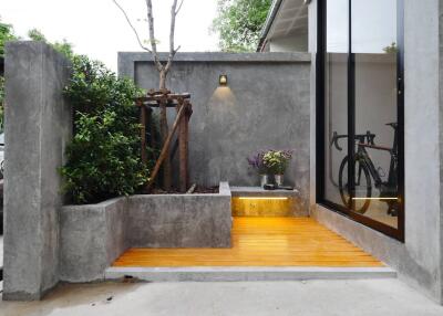 Modern outdoor entrance with concrete and wood elements