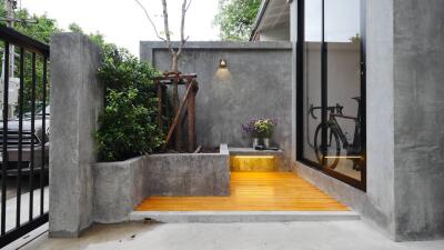 Modern outdoor entrance with concrete and wood elements