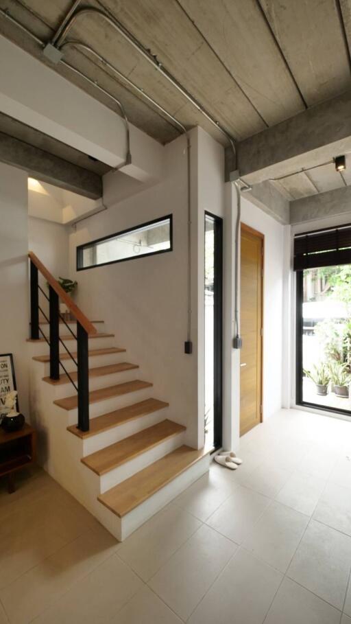 Modern entryway with stairs and natural light