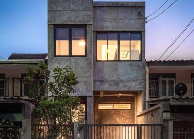 Exterior view of a modern two-story house at dusk