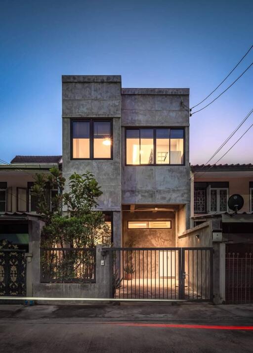 Exterior view of a modern two-story house at dusk