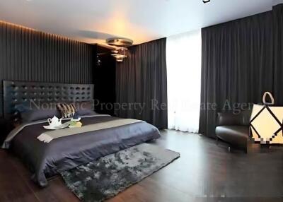 modern bedroom with dark decor and natural light