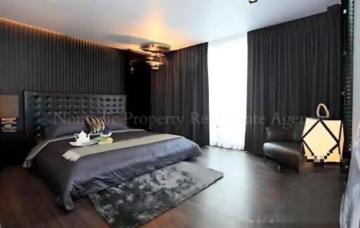 modern bedroom with dark decor and natural light