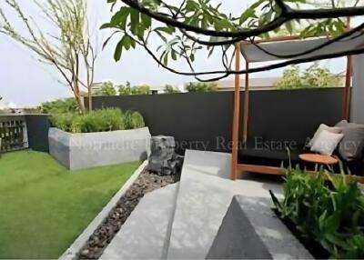 beautifully landscaped garden with seating area