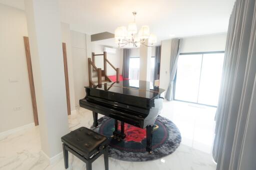 Living room with a piano and elegant decor