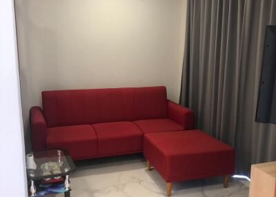 living room with red sofa and air conditioning