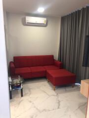 living room with red sofa and air conditioning