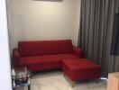 living room with red sofa and air conditioning