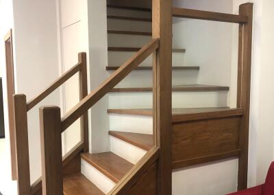 Wooden staircase with brown railing