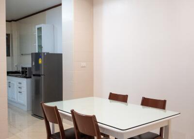 Dining area with table and chairs next to the kitchen