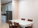 Dining area with table and chairs next to the kitchen