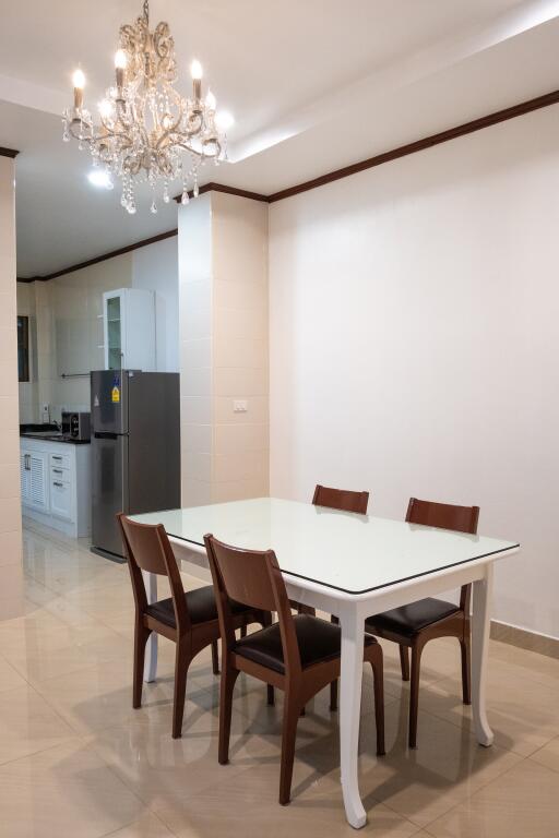 Dining area with table and chairs next to the kitchen