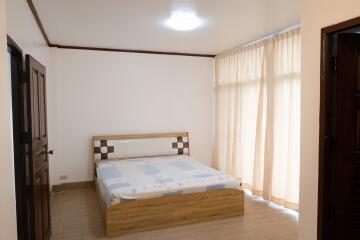 Bedroom with bed and large window