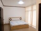 Bedroom with bed and large window