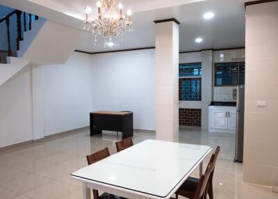 Dining area with chandelier and adjacent kitchen