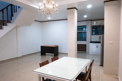 Dining area with chandelier and adjacent kitchen