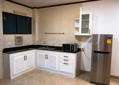 Modern kitchen with white cabinets and black countertops