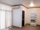 Bedroom with large window, air conditioning, and floor tiles