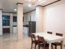 Kitchen and dining area with white cabinets and a glass dining table