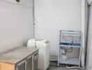 Laundry room with washing machine, sink, and storage cabinet