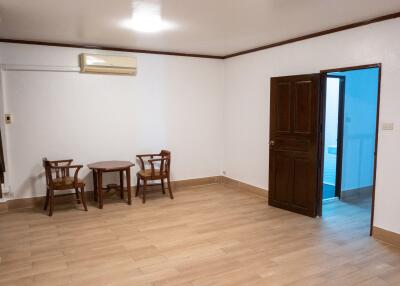 Minimalistic living area with wooden chairs and central table