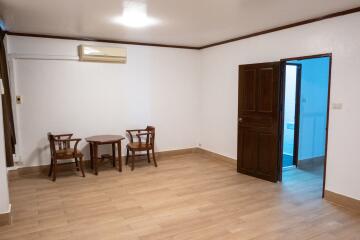 Minimalistic living area with wooden chairs and central table