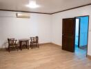 Minimalistic living area with wooden chairs and central table