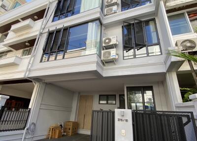 Modern multi-story residential building with balconies and air conditioning units