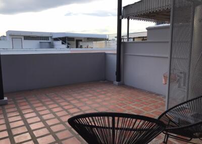 Rooftop terrace with tiled flooring and seating