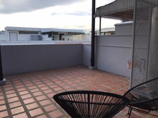 Rooftop terrace with tiled flooring and seating